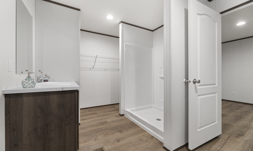 This master bathroom features a luxurious walk-in shower and open closet.