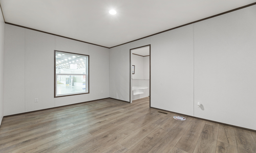 Spacious master bedroom with beautiful laminate flooring that continues into the adjoining master bathroom.