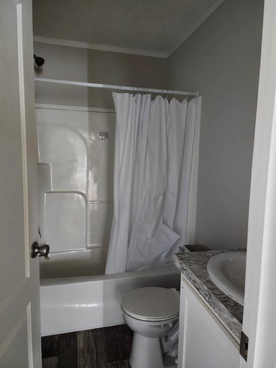 This charming bathroom with tub/shower combo is perfect for any family.